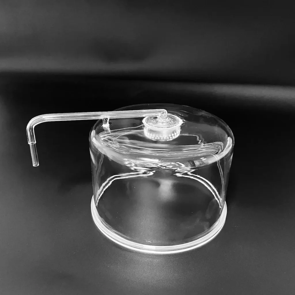 Close-up of internal quartz gas distributor showerhead inside a semiconductor reaction chamber.